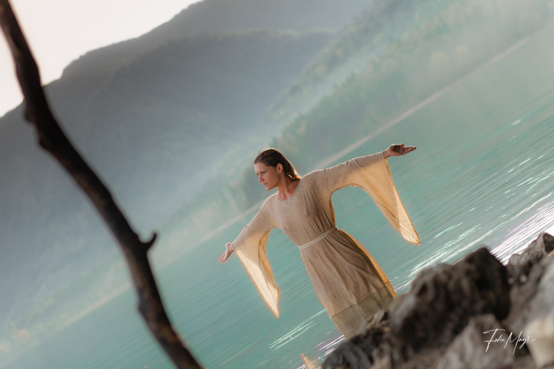 Mittelalterlich gekleidete Frau, naß im Wasser am Ufer des Walchensee