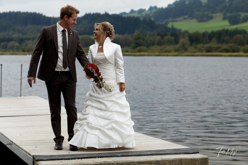 Brautpaar auf Steg an einem See